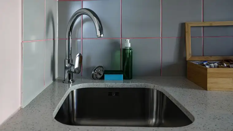 Stainless steel undermount sink with chrome faucet, dish soap and sponge